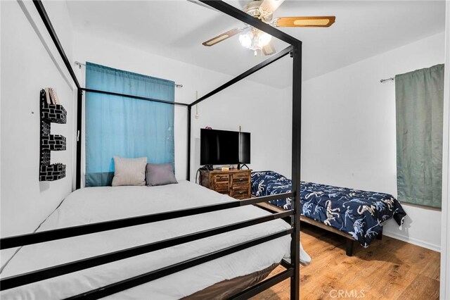 bedroom with ceiling fan and wood-type flooring