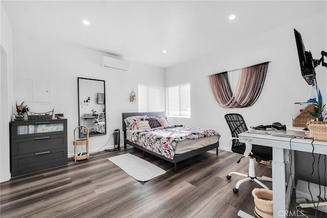 bedroom with an AC wall unit and dark hardwood / wood-style flooring