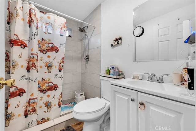 bathroom featuring toilet, vanity, and a shower with curtain