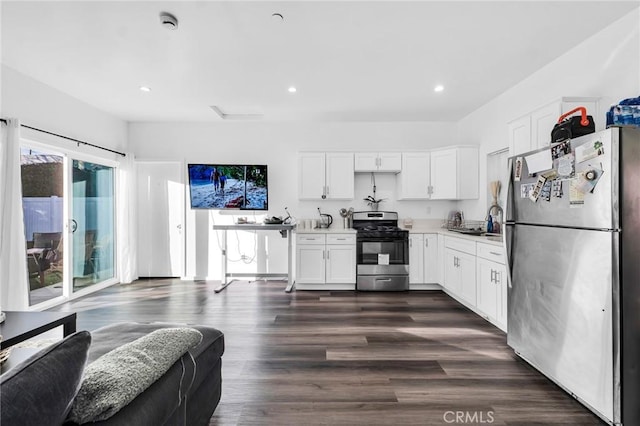 kitchen with dark wood-type flooring, white cabinets, appliances with stainless steel finishes, and sink