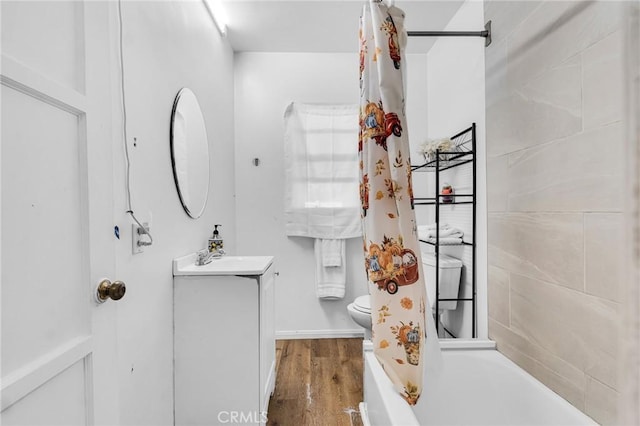 full bathroom with toilet, shower / bath combination with curtain, hardwood / wood-style flooring, and vanity