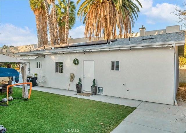 back of property with a patio, a lawn, and central air condition unit