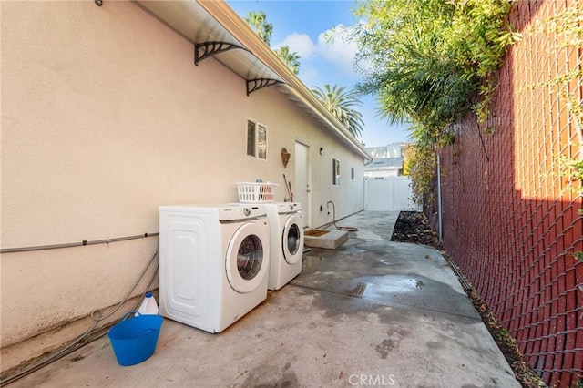 clothes washing area featuring independent washer and dryer