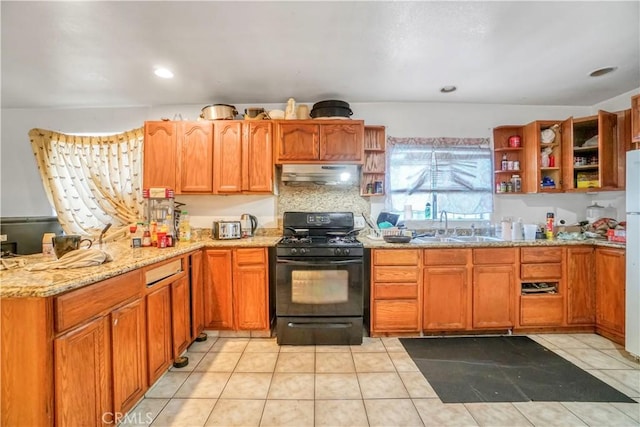 kitchen with sink, black range with gas stovetop, light stone counters, decorative backsplash, and light tile patterned floors