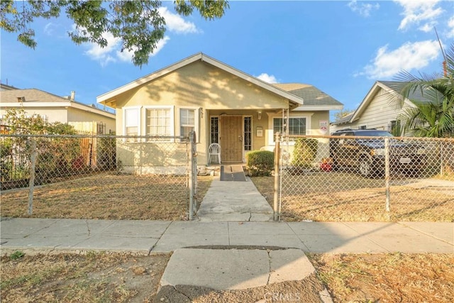 151 W 110th St, Los Angeles, CA 90061 - bungalow-style home with a fenced front yard and stucco siding