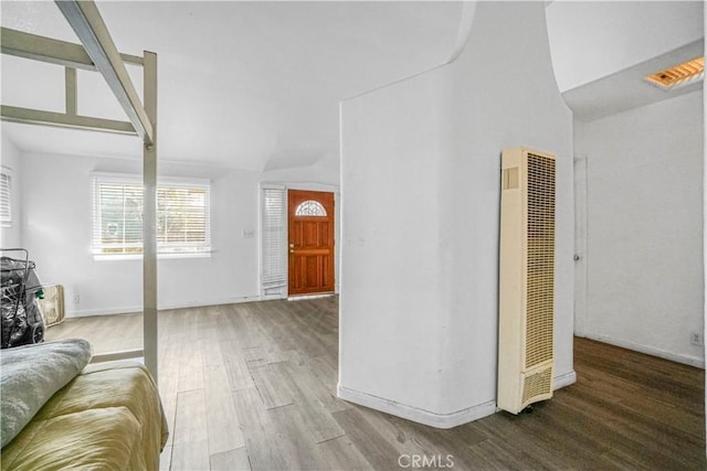 living room with hardwood / wood-style floors and lofted ceiling