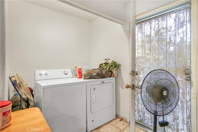 laundry room featuring washer and dryer and light tile patterned floors