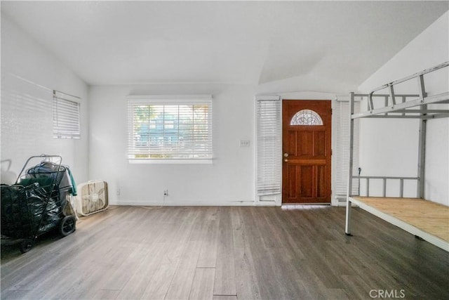 entrance foyer with hardwood / wood-style floors and vaulted ceiling