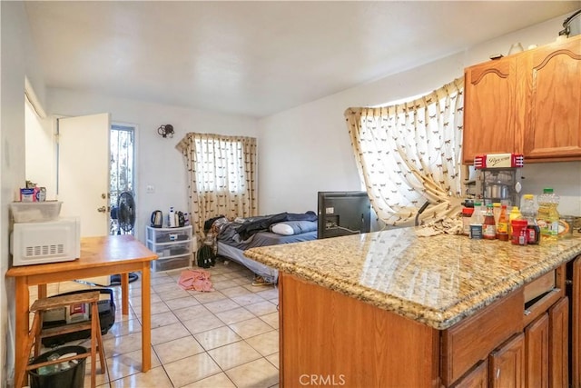 kitchen featuring light stone countertops and light tile patterned floors