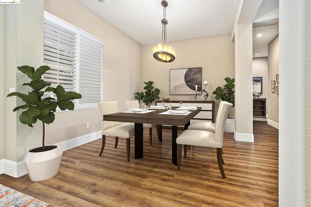 dining space with an inviting chandelier and hardwood / wood-style floors