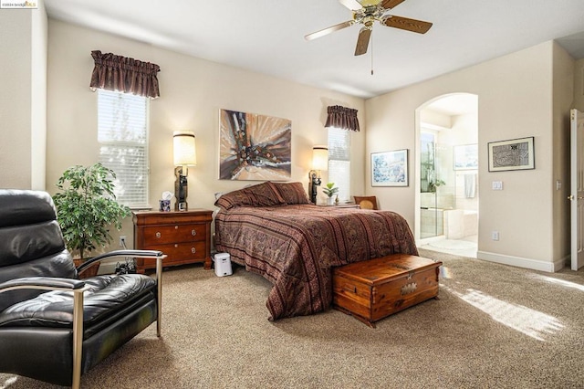 carpeted bedroom featuring connected bathroom and ceiling fan