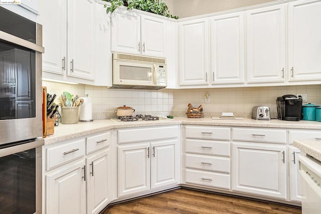 kitchen featuring white cabinetry, white appliances, tasteful backsplash, and dark hardwood / wood-style floors