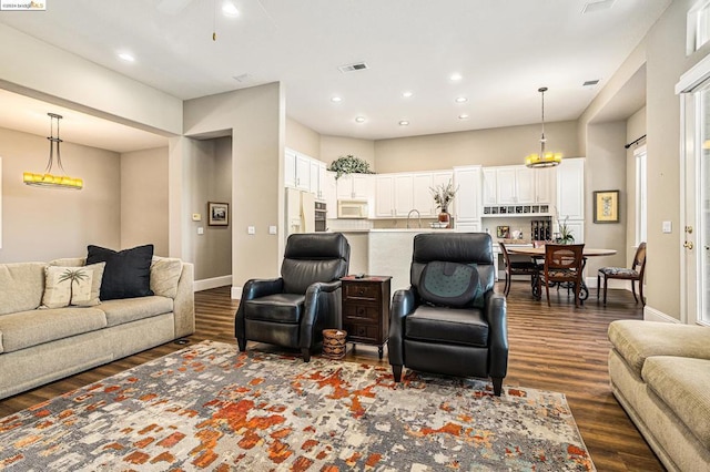 living room featuring dark hardwood / wood-style floors and sink