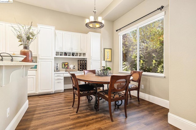 dining room featuring dark hardwood / wood-style floors and a chandelier