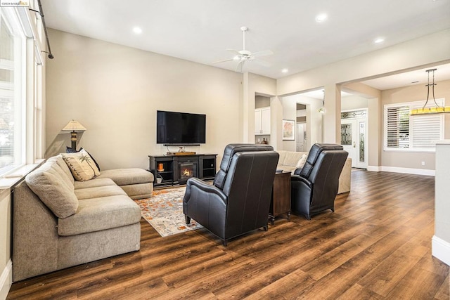 living room with dark hardwood / wood-style floors and ceiling fan