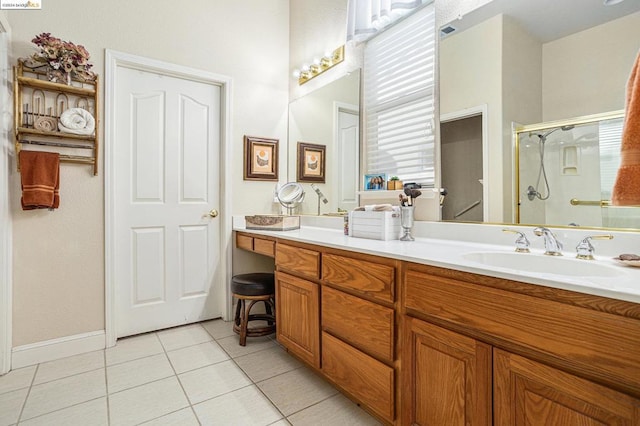 bathroom featuring tile patterned floors, an enclosed shower, and vanity