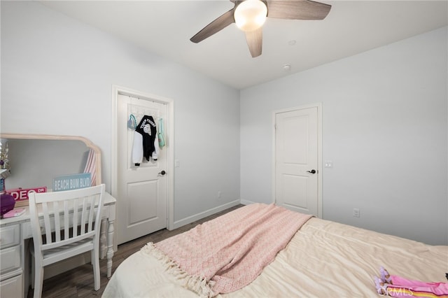 bedroom with ceiling fan and dark hardwood / wood-style flooring