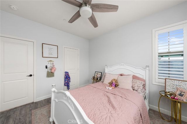 bedroom with ceiling fan and dark hardwood / wood-style flooring