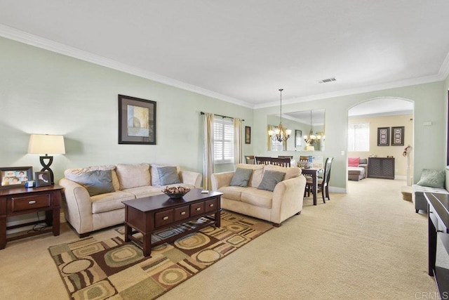 carpeted living room featuring crown molding and an inviting chandelier