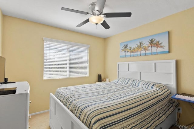 bedroom with ceiling fan and light carpet