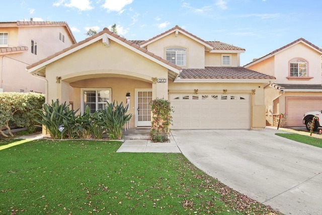 mediterranean / spanish home featuring a garage and a front yard