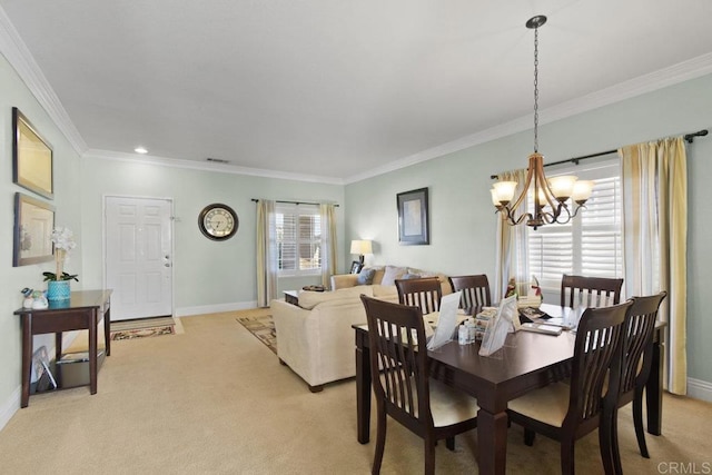 carpeted dining space with plenty of natural light, crown molding, and a chandelier