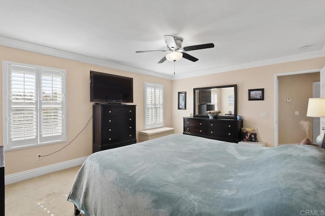 carpeted bedroom featuring ceiling fan and crown molding