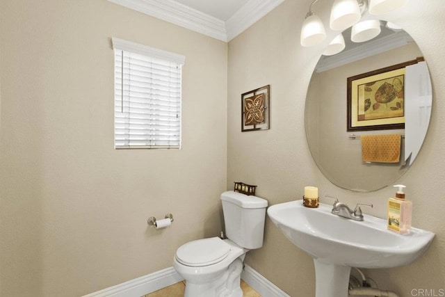 bathroom featuring toilet, ornamental molding, and sink