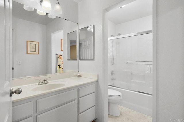 full bathroom featuring combined bath / shower with glass door, vanity, and toilet