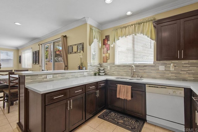 kitchen featuring kitchen peninsula, a wealth of natural light, sink, and white dishwasher