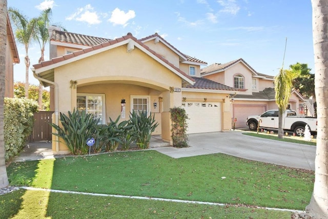 mediterranean / spanish home with a garage and a front lawn