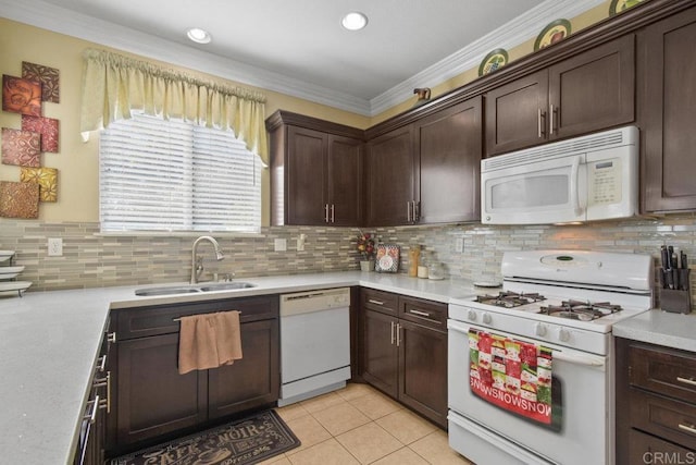 kitchen with white appliances, backsplash, sink, ornamental molding, and dark brown cabinets