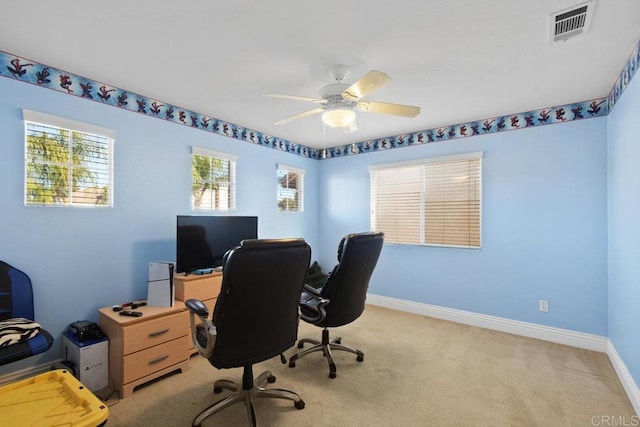 home office featuring ceiling fan and light carpet