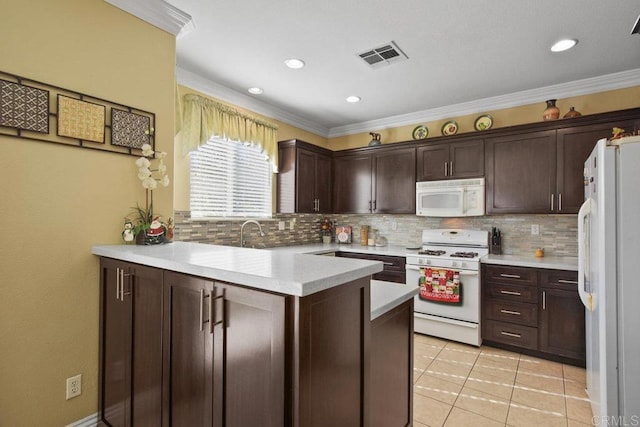 kitchen featuring kitchen peninsula, dark brown cabinetry, white appliances, and ornamental molding