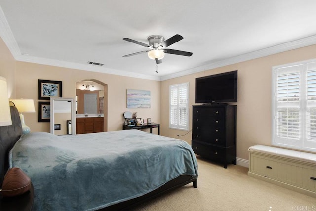 bedroom featuring connected bathroom, multiple windows, ceiling fan, and ornamental molding