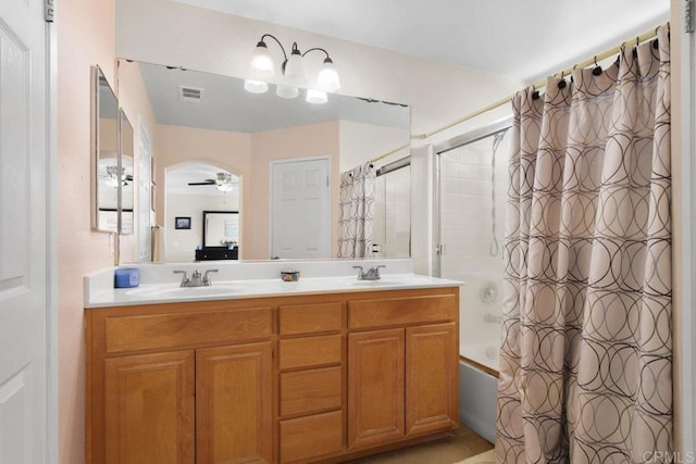 bathroom featuring vanity, ceiling fan, and shower / tub combo