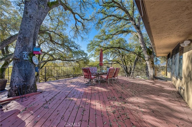 wooden deck featuring outdoor dining area
