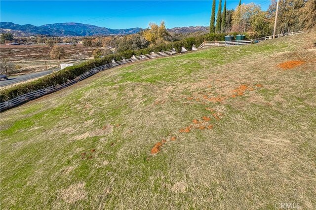 view of yard with a mountain view and a rural view