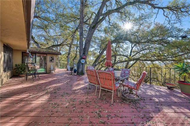 view of patio / terrace featuring outdoor dining space and a wooden deck