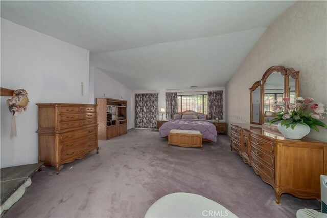 carpeted bedroom featuring lofted ceiling