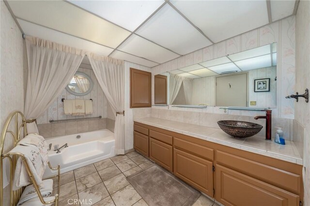 bathroom with vanity and a bath