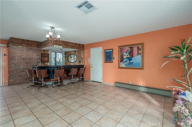 dining space featuring visible vents, a textured ceiling, tile patterned floors, a notable chandelier, and baseboard heating