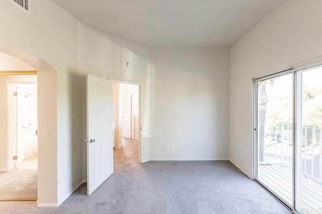 unfurnished room with light colored carpet