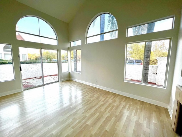 unfurnished sunroom with plenty of natural light and vaulted ceiling