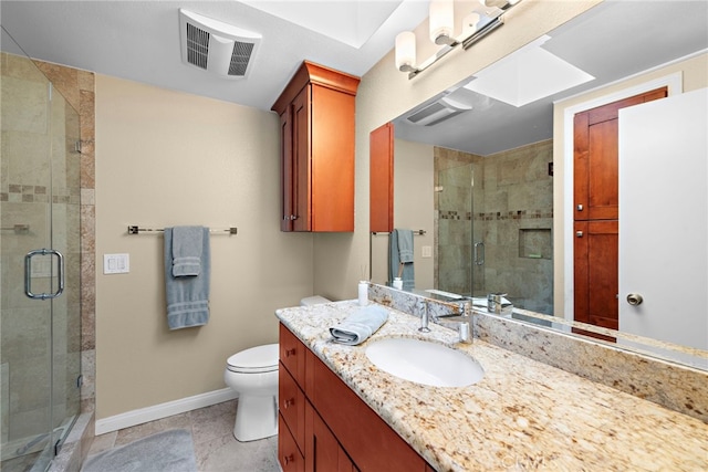 bathroom with tile patterned flooring, vanity, toilet, and walk in shower