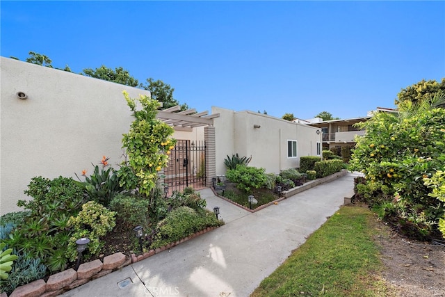 view of side of property featuring a pergola