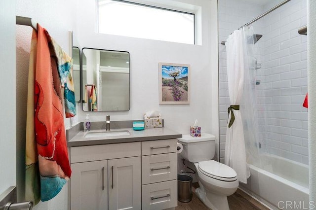 full bathroom featuring toilet, shower / bath combination with curtain, and vanity