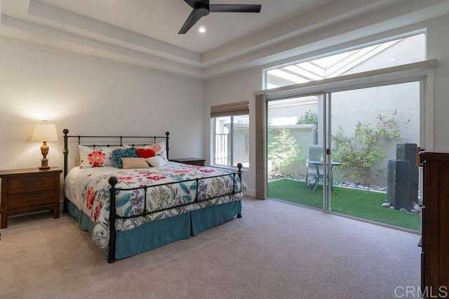 bedroom with recessed lighting, a ceiling fan, access to exterior, a tray ceiling, and carpet