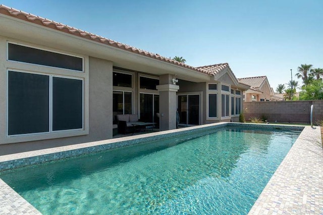 view of pool featuring fence, a fenced in pool, and a patio