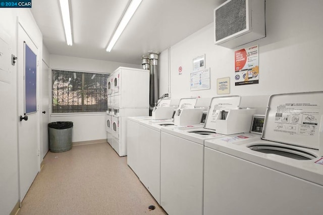 washroom with stacked washer and clothes dryer and washing machine and clothes dryer